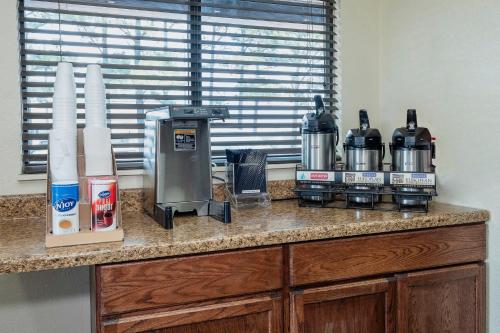 a counter top with a coffee machine on it at Red Roof Inn Jackson North – Ridgeland in Ridgeland