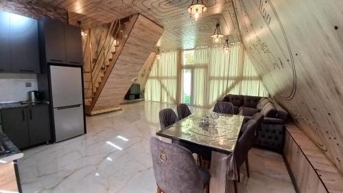 a dining room with a table and some chairs at Gabala 7 Villa in Vǝndam