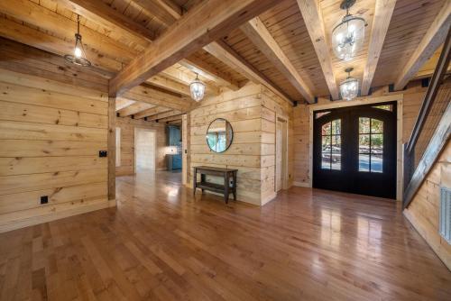 a large room with wooden walls and a wooden floor at Brewer Hollow in Lake Lure