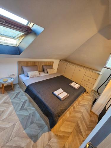 a bedroom with a bed in the attic at Booking Apartment Rajiceva in Belgrade