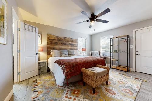 a bedroom with a bed and a ceiling fan at Meadow Creek Cottage in Wimberley