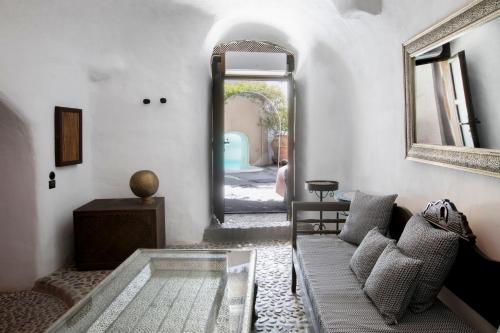 a living room with a couch and a mirror at Ducato Wine Village in Megalokhori