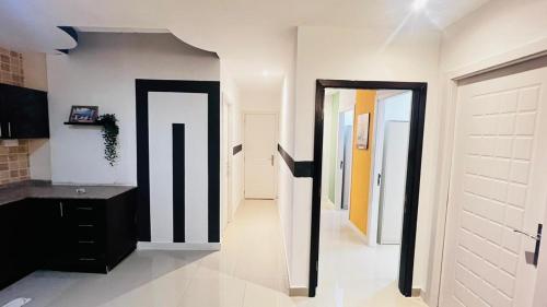 a hallway with black and white walls and doors at Glamorous Partition Room in Barsha 1 Near Metro in Dubai