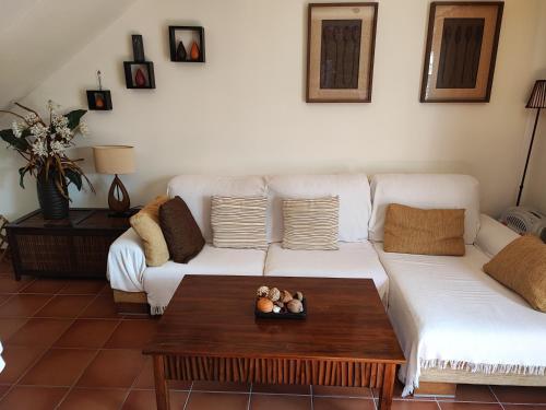 a living room with two white couches and a coffee table at Adosado en Alcossebre El Faro in Alcossebre