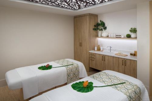 a hospital room with two beds and a sink at The Alfond Inn in Orlando