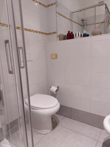 a white bathroom with a toilet and a shower at Appartamento Piazzetta La Maddalena in Savona