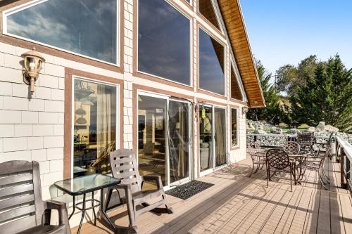a porch with chairs and a table and windows at Mac's Place in Manson
