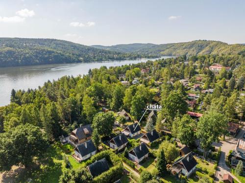 an aerial view of a village next to a river at Chajda Slapy in Slapy