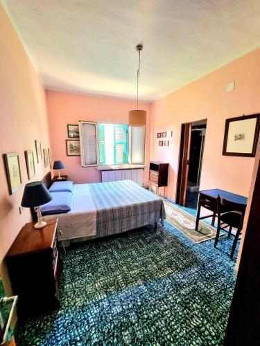 a bedroom with a bed and a table and chairs at Casa Cambini in Marina di Massa
