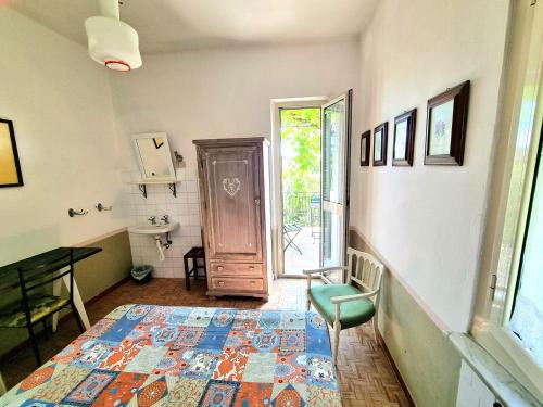 a room with a door and a table and a rug at Casa Cambini in Marina di Massa