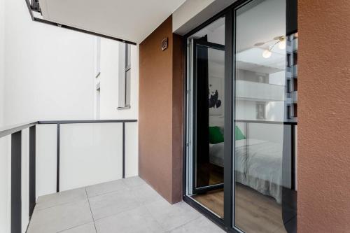 a room with glass doors leading to a bedroom at Enjoy! Ursus in Warsaw