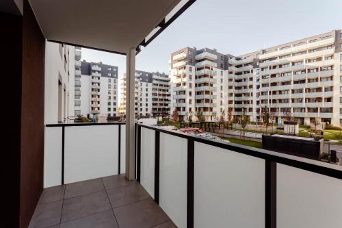 a balcony with a view of some buildings at Enjoy! Ursus in Warsaw