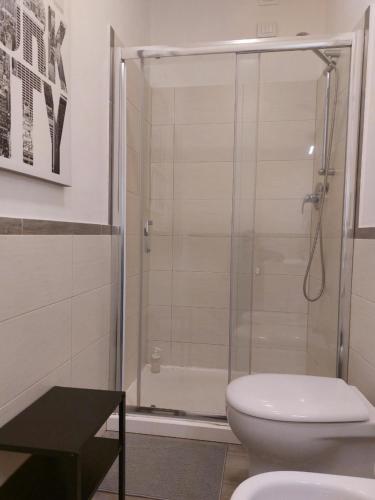 a bathroom with a shower and a toilet at Piazzetta dei Consoli Apartment in Savona