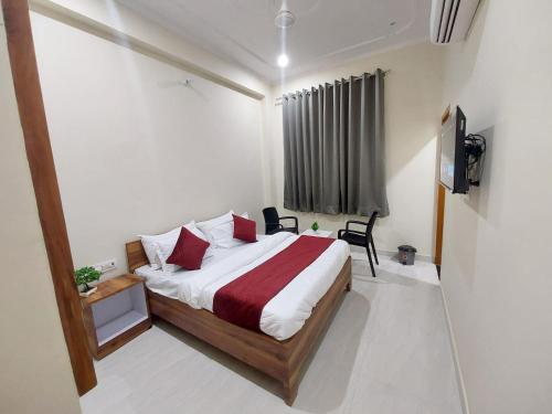 a bedroom with a bed and a television in it at HOMEWOOD SUITES Near Jaipur Airport in Jaipur