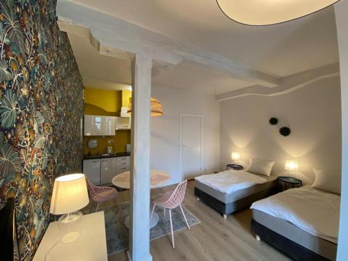 1 dormitorio con 2 camas, mesa y sillas en Studio Rynek 32, en Jawor