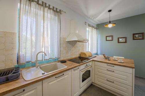 a kitchen with a sink and a counter top at Villa Boljunka in Boljun - Haus für 8 Personen in Boljun
