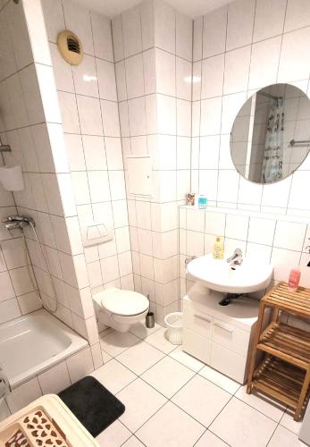 a white bathroom with a toilet and a sink at Mainz-Unterkunft in Mainz