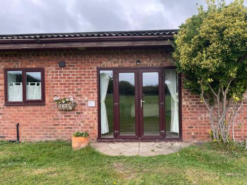 a brick house with a sliding glass door at Strawberry Fields in Liverpool