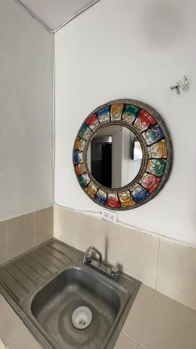 a bathroom with a mirror and a sink at Brisa del mar Holbox in Holbox Island