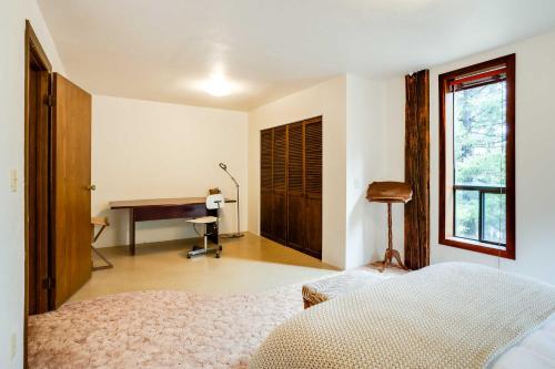 a bedroom with a bed and a desk in it at Peaceful Applegate River Valley Sanctuary! in Grants Pass