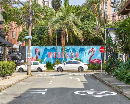 a street with two cars parked in a parking lot at Elemont Hotel in Medellín