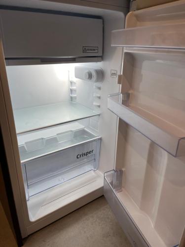 an empty refrigerator with its door open with its door open at U Filipa in Gdynia