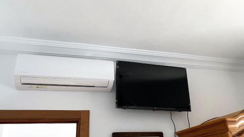 a flat screen tv hanging on a wall at Apartamento Doble Vacacional Carmona in Carmona