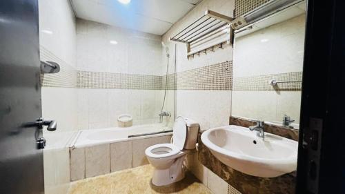 a bathroom with a toilet and a sink at Traveller Partition Room in Al Barsha 1 Near Metro in Dubai