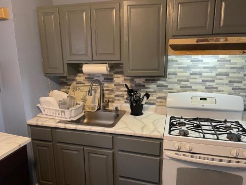 a kitchen with a sink and a stove at Mo Short Term Rentals in Mount Vernon
