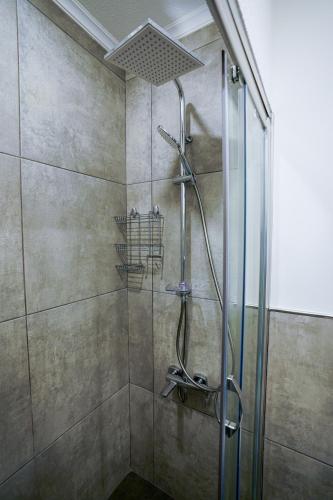 a bathroom with a shower with a glass door at Merkuri apartments in Istanbul