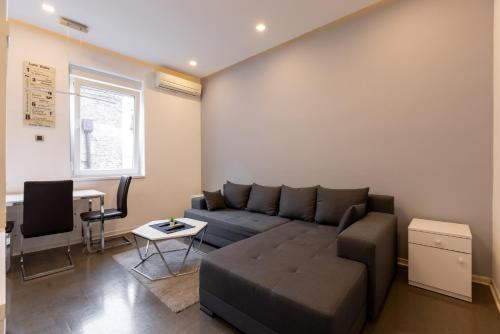 a living room with a couch and a table at Central Park Apartments in Belgrade