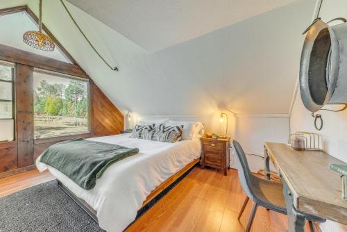 a bedroom with a bed and a desk and a window at Ruidoso Rental with Private Hot Tub Walk to Midtown in Ruidoso