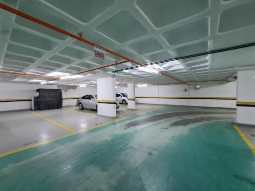 a parking garage with a car parked in it at APT 804 - Brava Beach - 3 Quartos - 2 Vagas Garagem in Cabeçudas