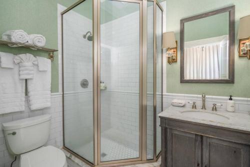 uma casa de banho com um chuveiro, um WC e um lavatório. em Leland Suite at Mirabelle em Savannah