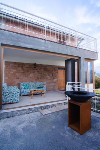 a patio with a couch and a table at [vista Sibillini] Villa Amici in Verri