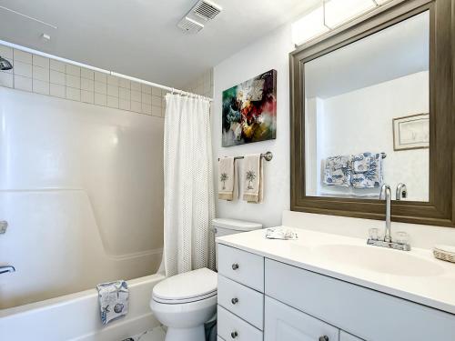 a white bathroom with a sink and a toilet at Welcome To The Paradise in Fort Myers Beach