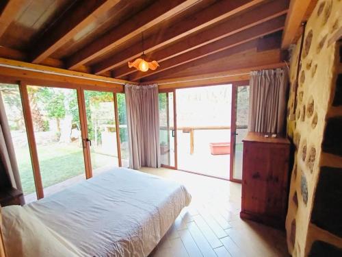 a bedroom with a bed and a large window at Casa Romantica in Los Palmitos