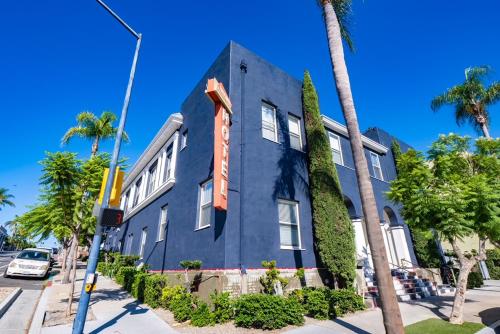 a blue building with an orange sign on it at Balboa Park Hotel in Downtown Little Italy in San Diego