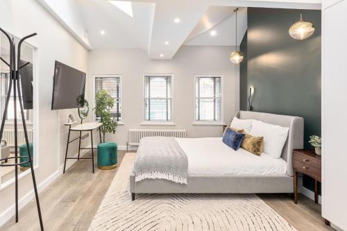 a bedroom with a bed and a flat screen tv at Be London - The Chinatown Residences in London