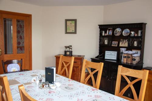 a dining room with a table and chairs at Creeghduff Lodge in Downpatrick