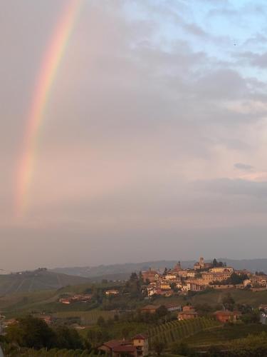 a rainbow in the sky over a town at I Quattro Grappoli in Neive