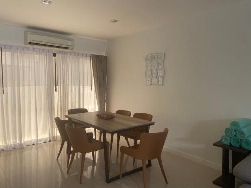 a dining room with a table and chairs at Country club townhouse in Bang Tao Beach
