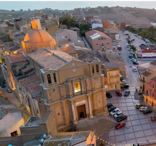an old building with a clock tower in a city at La Foggia seaside paradise in Siculiana