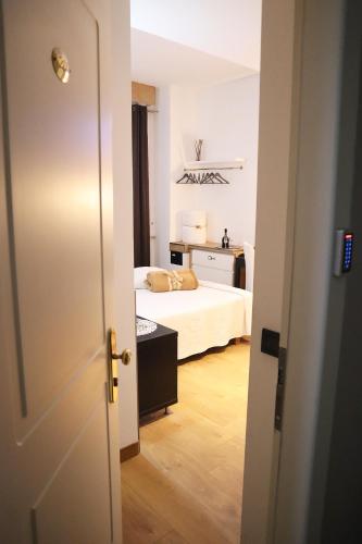 a small bedroom with a bed and a room with a door at Villa Alba Boutique Hotel in Pescara