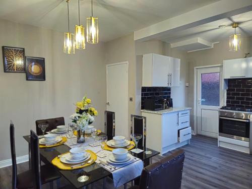 a kitchen and dining room with a table and chairs at Clifton House, For Holidays, Contractors, Relocation, Work, Etc, Free Parking and Wifi in Preston