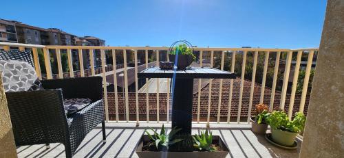 a balcony with a table with potted plants on it at Sunshine House in Alessandria