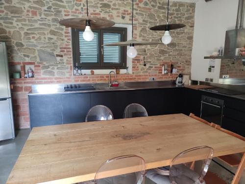 a kitchen with a wooden table and some chairs at Casa Matta in Arezzo
