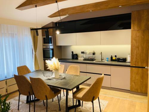 a kitchen with a dining room table and chairs at Villa Selzo lux in Pale