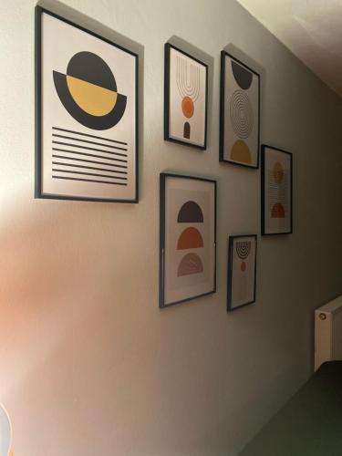 a wall with framed pictures on a wall at Cozy house in Xanthi