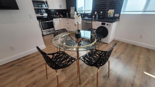 a kitchen with a glass table and four chairs at Gated private house with own parking Sherman Oaks in Los Angeles